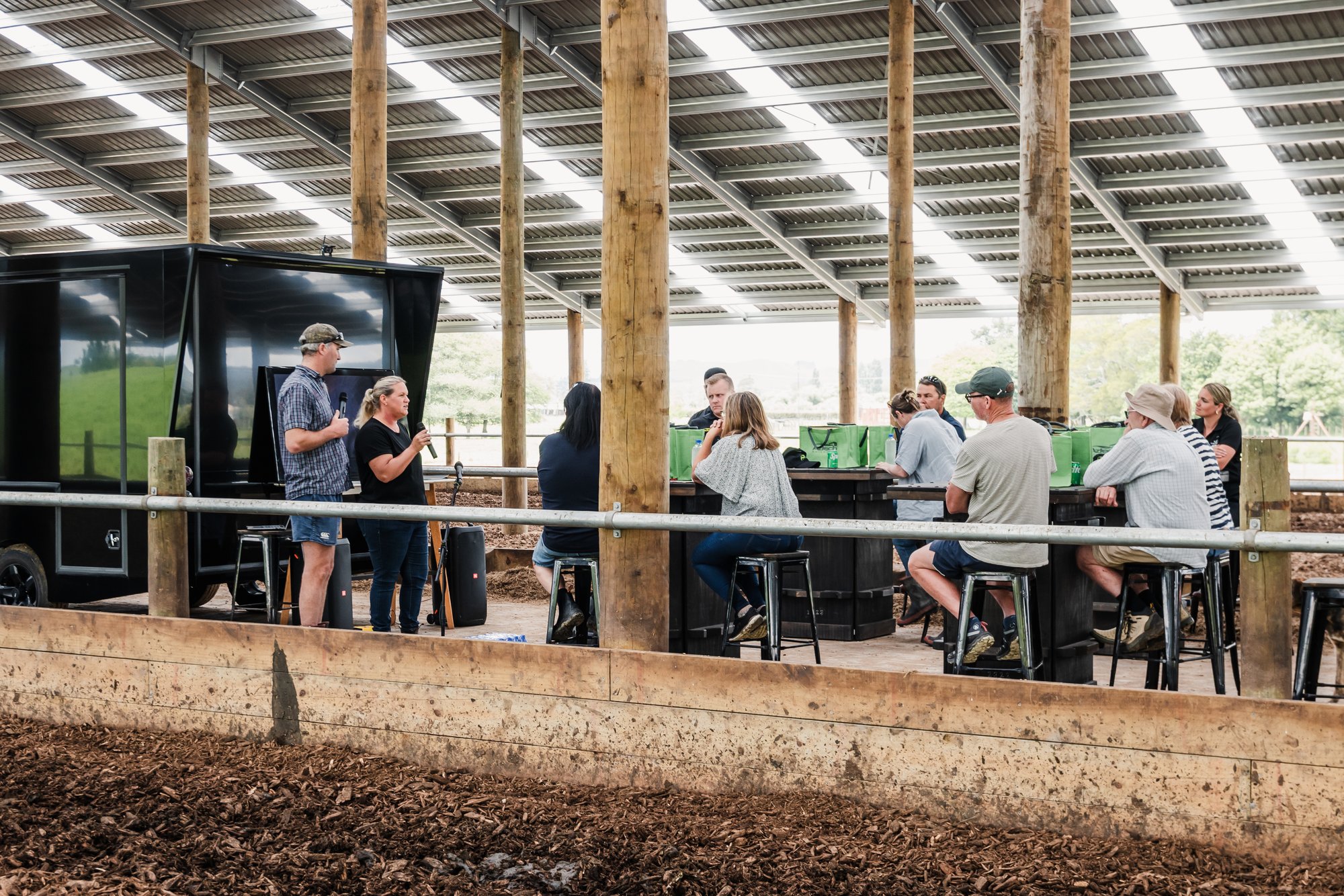 Farmers seated inside a composting barn at an Aztech open day, with catering trailer and presenter in the background Farmers seated inside a composting barn at an Aztech open day, with catering trailer and presenter in the background